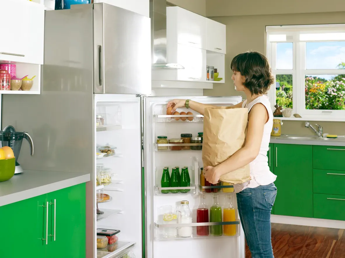 A repaired refrigerator stocked with fresh food in a family kitchen.